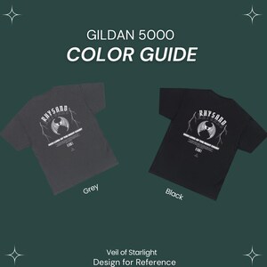 May include: A color guide for Gildan 5000 t-shirts featuring a design with the text "RHYSAND" and a graphic of a winged creature. The guide shows the t-shirt in grey and black.