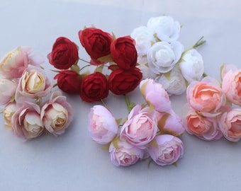 May include: An assortment of artificial flowers in various colors. The image features clusters of red, white, and pink roses. The roses have multiple petals and green stems, perfect for crafting or decorative purposes.