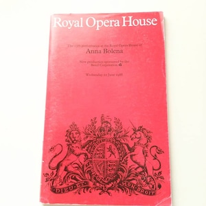 May include: A red Royal Opera House program for the performance of Anna Bolena. The cover displays the title, performance details, and date: Wednesday 22 June 1988. The program features a crest with a lion and unicorn.