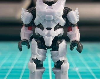 May include: A light grey action figure of a futuristic soldier, with detailed armour plating and a helmet. The figure has black joints and red accents on the arms, standing on a black base.