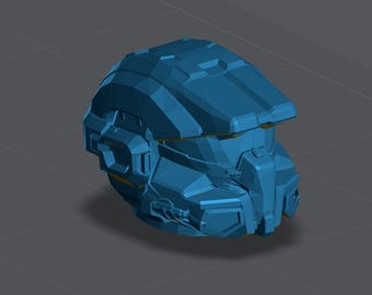 May include: A blue, angular helmet with a visor and various geometric details. The helmet appears to be a 3D model or a digital rendering, showcasing a futuristic design. The overall shape suggests a protective head covering, possibly for a science fiction or gaming context.