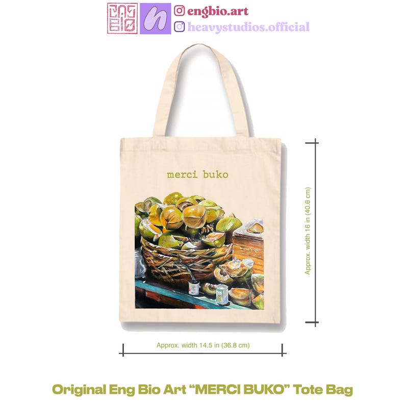 May include: Cream-colored tote bag with the text "merci buko" and a detailed illustration of a basket filled with green fruit. The bag is approximately 16 inches (40.6 cm) high and 14.5 inches (36.8 cm) wide. The bag is labeled "Original Eng Bio Art MERCI BUKO Tote Bag".