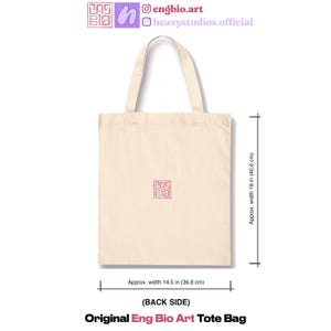 May include: Cream-colored tote bag with a red square logo. The bag is approximately 14.5 inches wide and 16 inches tall. The text "Original Eng Bio Art Tote Bag" is at the bottom. The back side of the bag is shown.