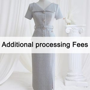 May include: A pale grey tweed dress with short sleeves, a notched collar, and a belted waist. The dress has decorative buttons and a knee-length skirt with a front slit. The text "Additional processing Fees" is displayed across the image.