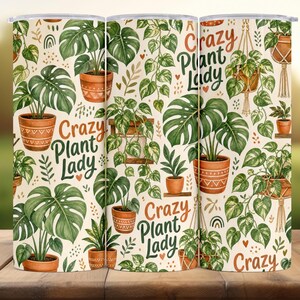 Könnte beinhalten: Ein zylindrischer Becher mit einem sich wiederholenden Muster aus verschiedenen grünen Topfpflanzen, Hängepflanzen und kleinen Herzen auf cremefarbenem Grund. Der Text "Crazy Plant Lady" ist in grüner und orangefarbener Schrift gedruckt.