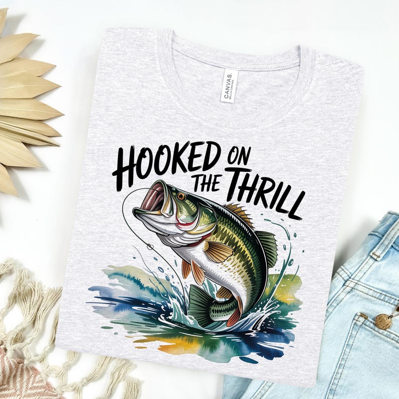 a t - shirt that says hooked on the thrill with a fish on it