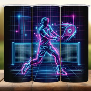 May include: A black tumbler featuring a neon illustration of a tennis player in action. The design uses vibrant blue and pink lines to depict the player, racket, and net against a grid background. The tumbler is designed for beverages.