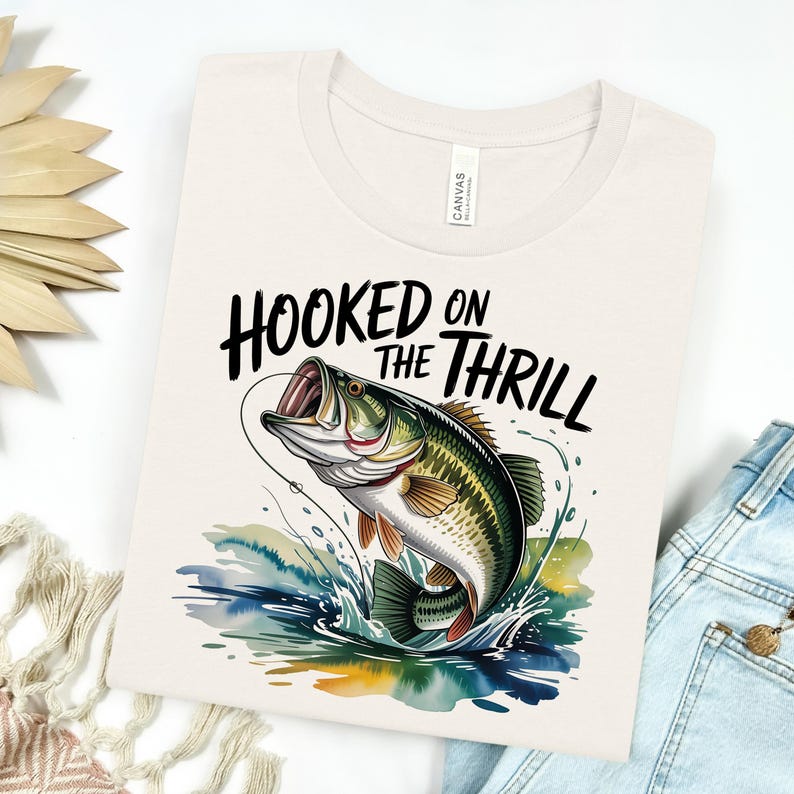 a t - shirt that says hooked on the thrill with a fish on it