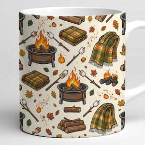 May include: A white ceramic mug featuring a repeating pattern of camping-themed illustrations including orange campfires in metal fire pits, toasted marshmallows on sticks, folded green and orange plaid blankets, and stacks of brown firewood logs.