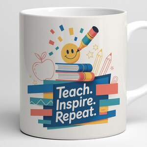 May include: White ceramic mug with a colorful design featuring a smiling face, books, pencils, and the words "Teach. Inspire. Repeat." in a blue and orange banner. The mug has a white handle.