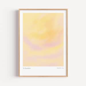 May include: A framed art print featuring an abstract watercolor design in shades of yellow, peach, and lavender. The print is in a light wood frame and includes the text "la lumière" and "September, 2023".