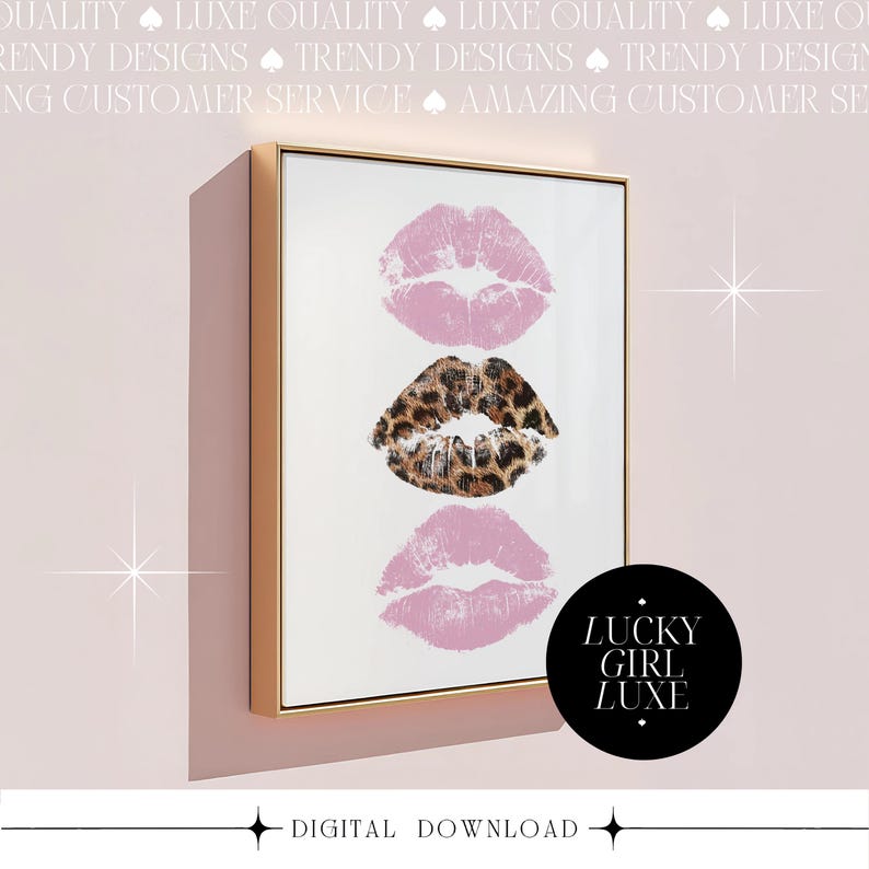 May include: A framed print featuring three lip prints: two in pink and one in a leopard print pattern. The artwork is in a gold frame and includes the text "LUCKY GIRL LUXE" on a black circle. The words "DIGITAL DOWNLOAD" are at the bottom.