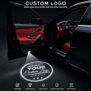 May include: A car door projector light casting a circular white logo onto the ground. The projection displays the text CUSTOM LOGO, YOUR DESIGN, YOUR Custom Logo, and YOUR STYLE with stars. The car interior features red leather door panels.