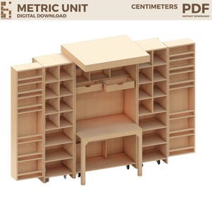 May include: A light-coloured wooden craft workstation featuring a central desk with two drawers, flanked by multiple vertical storage shelves and compartments. The unit includes text reading METRIC UNIT DIGITAL DOWNLOAD CENTIMETERS PDF.