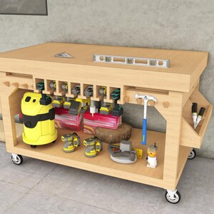 May include: A wooden mobile workbench with a yellow and black vacuum cleaner, power tools, and a spirit level on the top shelf. The workbench has a built-in tool holder and a drawer for storing tools.