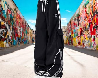 May include: Black cargo pants with white side stripes and a white drawstring. The pants have a loose fit and are made of a lightweight fabric.