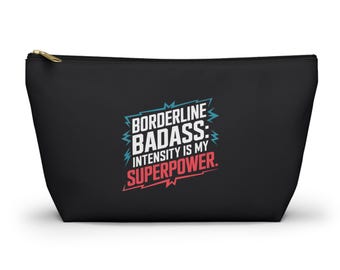 May include: Black zippered makeup bag with the text "Borderline Badass: Intensity is my Superpower." in white, red, and blue lettering.
