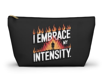 May include: Black zippered pouch with the text "I EMBRACE MY INTENSITY" in white, with a silhouette of a person in front of flames. The pouch has a gold zipper.
