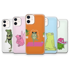 May include: A collection of phone cases featuring cartoon frogs in various poses. Designs include a frog in a yoga pose, a frog with fairy wings, and a frog wearing a cowboy hat. The cases have different colored backgrounds.