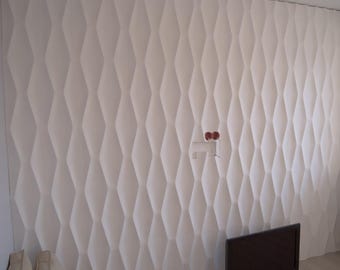 May include: White wall with a 3D diamond pattern. The wall is made of a textured material that creates a raised diamond pattern.