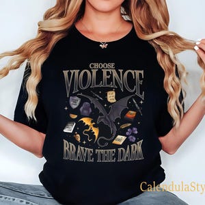 May include: Black t-shirt with a graphic print of a dragon and the text "Choose Violence Brave the Dark".
