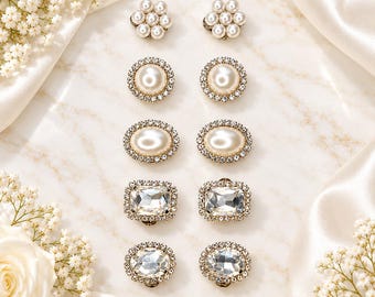 May include: Five pairs of decorative buttons arranged in two vertical columns. The set includes flower-shaped pearl clusters, round pearl cabochons with crystal borders, oval pearl cabochons with crystal borders, and two styles of rectangular crystals.