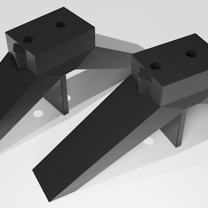 May include: Two black plastic corner braces with a triangular shape and two holes on the top surface.