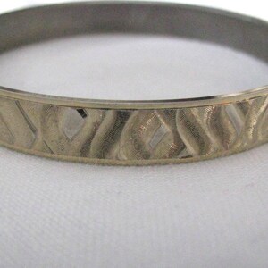 Textured gold tone vintage bangle bracelet.