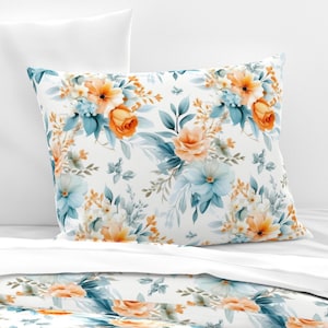 May include: A white pillowcase with a floral pattern featuring orange and blue flowers. The pillowcase has a white background with a repeating pattern of orange and blue flowers.