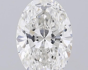 May include: A clear oval-shaped diamond with a brilliant cut. The diamond is set on a white stand.