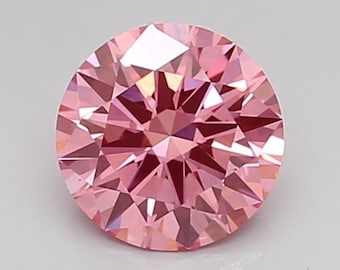 Puede incluir: Un diamante redondo rosa con talla brillante y muchas facetas.
