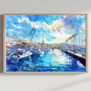 May include: A watercolor painting of a marina featuring several white boats docked in calm blue water under a bright sky with clouds. Palm trees line the shore near buildings, and the scene is framed by a light-colored wooden frame.