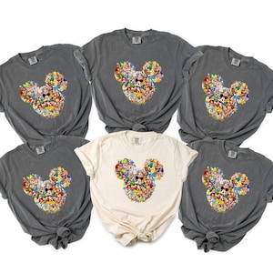 May include: A set of three ceramic mugs with a speckled, matte finish. The mugs are in shades of cream, light gray, and dark gray. Each mug has a simple, minimalist design and a rounded handle.