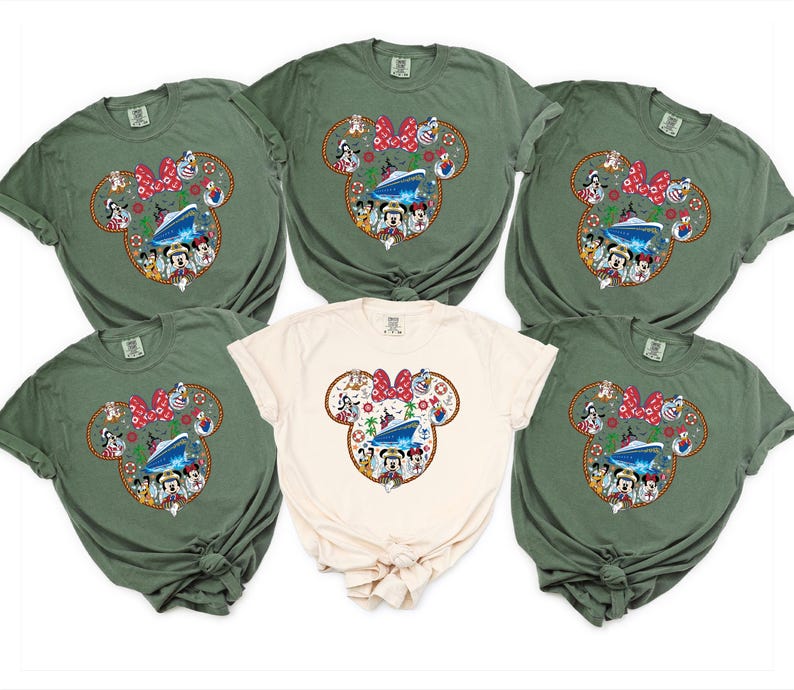 May include: Six t-shirts in shades of olive green and cream. Each shirt displays a Mickey Mouse head design with a cruise ship, characters, and a red bow. The shirts are short-sleeved and likely made of cotton.
