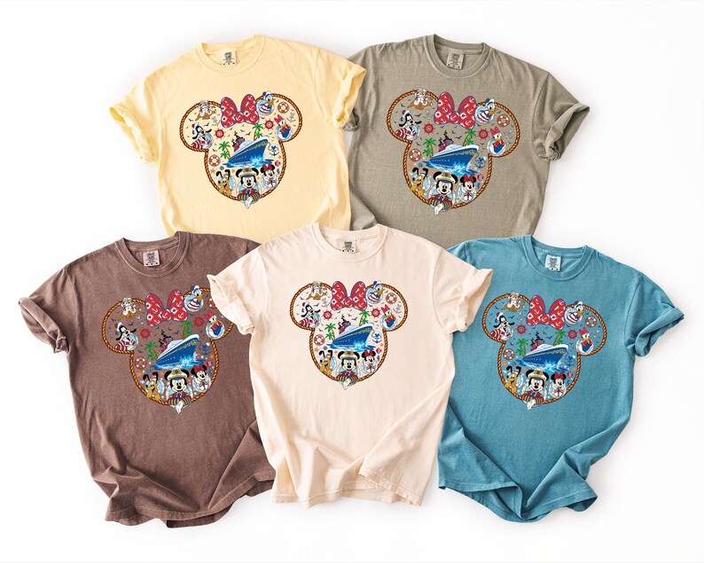 May include: Five short-sleeved t-shirts in yellow, grey, brown, cream, and blue. Each shirt has a Minnie Mouse head design with a red bow and a cruise ship graphic. The design includes cartoon characters.