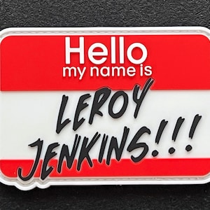 May include: White name tag with red and white stripes. The tag says "Hello my name is LEROY JENKINS!!!" in black text.