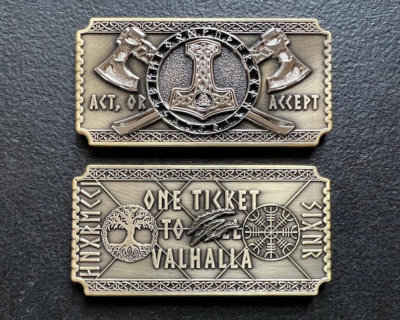 May include: Two gold-colored metal ticket replicas. The top ticket features a hammer and two axes with the text "Act, or Accept". The bottom ticket features a tree, a bird, a symbol, and the text "One Ticket to Valhalla".