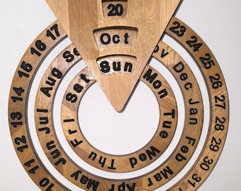 May include: A wooden perpetual calendar with a circular design. The calendar features a rotating dial with the days of the week and months of the year. The current date is set to October 20th.