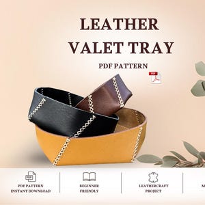 May include: A leather valet tray PDF pattern featuring three nested trays in black, brown, and mustard yellow. Each tray is constructed with visible white cross-stitching at the corners. The text LEATHER VALET TRAY PDF PATTERN is displayed.
