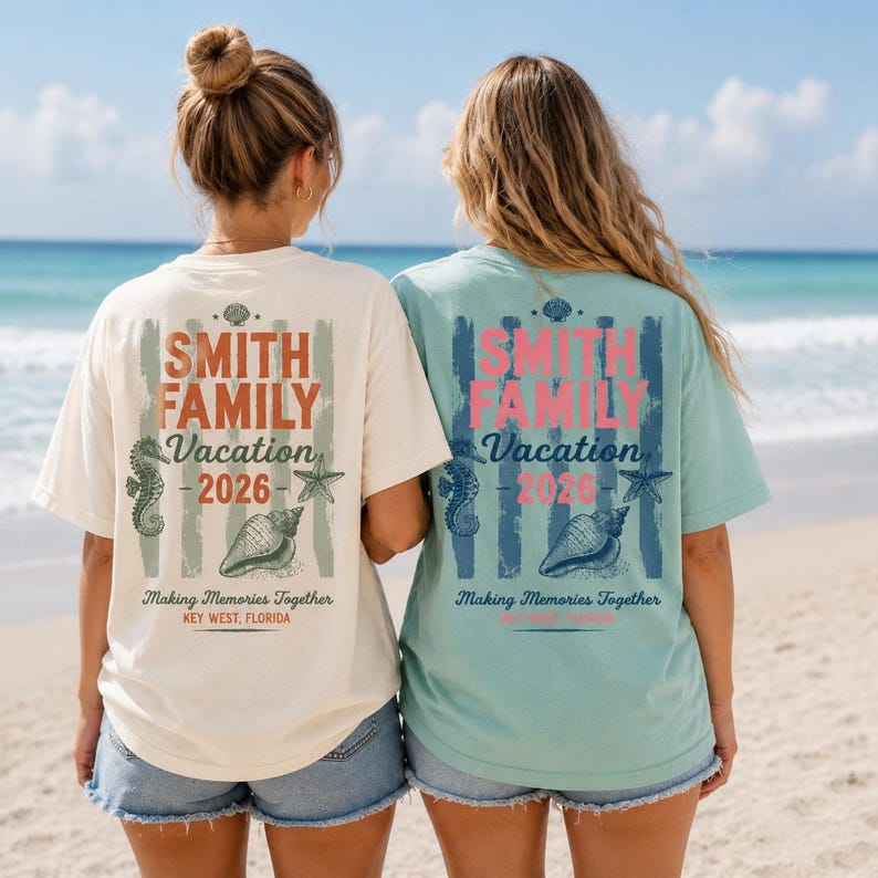 May include: Two short-sleeve t-shirts, one cream and one light green, featuring a back graphic with the text SMITH FAMILY Vacation 2026, Making Memories Together, and KEY WEST, FLORIDA, decorated with illustrations of a seahorse, starfish, and seashell.
