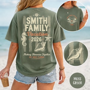 May include: A moss green short-sleeve t-shirt featuring a back graphic with the text Smith Family Vacation 2026, Making Memories Together, Key West, Florida, alongside illustrations of a seahorse, starfish, and seashell. A small front logo is included.