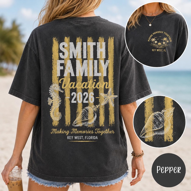 May include: A charcoal gray t-shirt featuring a back graphic with vertical gold stripes, a seahorse, a starfish, and a seashell. Text reads: SMITH FAMILY Vacation 2026, Making Memories Together, KEY WEST, FLORIDA. Front chest has a small sunset graphic.