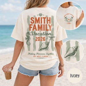 May include: An ivory t-shirt featuring a large back graphic with the text SMITH FAMILY Vacation 2026, Making Memories Together, KEY WEST, FLORIDA, alongside illustrations of a seahorse, starfish, and seashell over muted green vertical stripes.