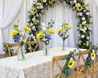 Zestaw centralnych elementów stołu w stylu vintage z motywem słonecznika i stokrotek, rustykalna kompozycja kwiatowa na wesele w stylu wiejskim z eukaliptusem, szklany wazon z kwiatami do dekoracji stołu