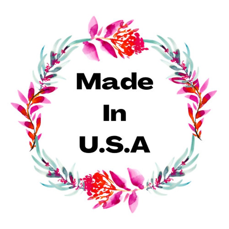 May include: A watercolor wreath of pink and green flowers with the text "Made in U.S.A." in the center.