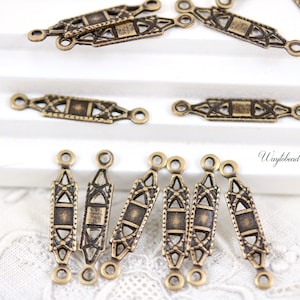 May include: A set of six antique gold-toned metal connector charms with intricate geometric designs. Each charm has two loops for attaching to jewelry or other crafts.