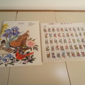 May include: A set of 50 United States Postal Service stamps featuring colorful illustrations of different birds. The stamps are arranged in a grid pattern on a white background. The text "The 1992 Fifty State Birds Commemorative Stamp Set" is printed on the top of the sheet.
