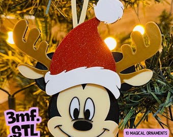 May include: A layered ornament featuring a cartoon mouse face with large ears, wearing a red glittery Santa hat with a white brim and pom-pom. The design includes tan antlers, black ears, and a cream-colored face. Text reads 3mf. STL and 10 MAGICAL ORNAMENTS.