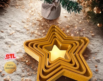 May include: A set of gold star-shaped cookie cutters, nested inside each other, with a star-shaped cutout in the center. The image includes the text "STL" and "Digital download". The cutters are on a textured surface with a small Christmas tree in the background.