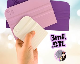 May include: Three rectangular craft squeegees in varying sizes and colors, including dark purple, light lavender, and white. Each tool features a molded flower design in the corner and horizontal ridges along the surface. Text reads 3mf. .STL.